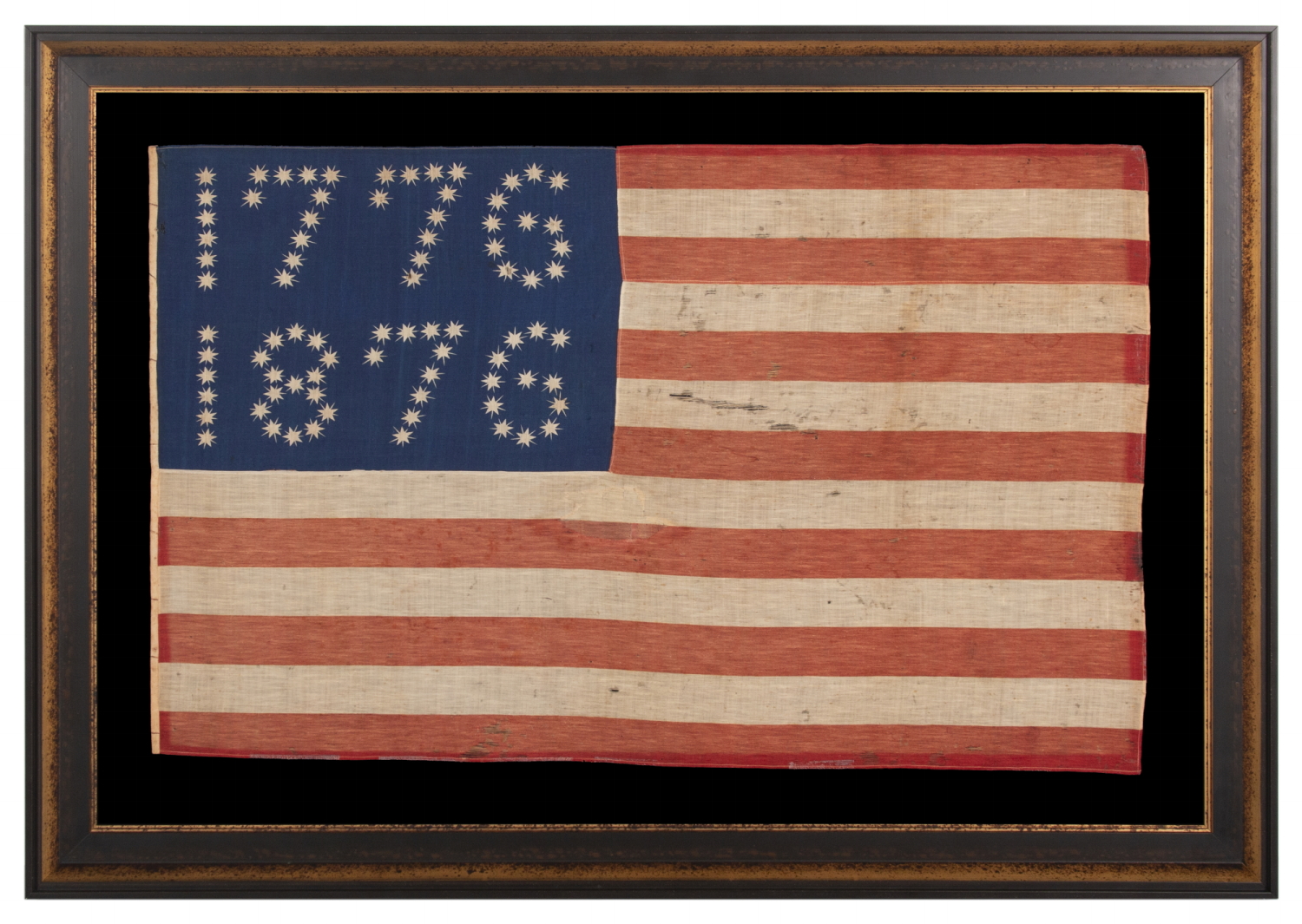 ANTIQUE AMERICAN FLAG WITH 10-POINTED STARS THAT SPELL “1776 – 1876”, MADE FOR THE 100-YEAR ANNIVERSARY OF AMERICAN INDEPENDENCE, ONE OF THE MOST GRAPHIC OF ALL EARLY EXAMPLES