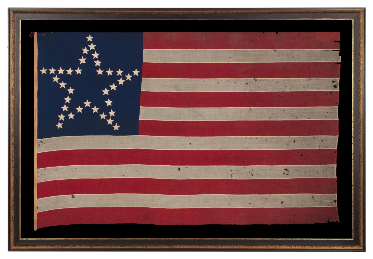 CIVIL WAR PERIOD ANTIQUE AMERICAN FLAG WITH 35 STARS IN A “GREAT STAR” OR “GREAT LUMINARY” PATTERN, A VERY RARE VARIETY WITH AN OPEN, LONE STAR PROFILE, LACKING STARS INSIDE OR BEYOND THE ARRANGEMENT; MADE circa 1863-65, REFLECTS THE ADMISSION OF WEST VIRGINIA TO THE UNION AS A FREE STATE, ANNEXED FROM VIRGINIA JUST 10 DAYS BEFORE THE BATTLE OF GETTYSBURG; PROBABLY WAR-CARRIED