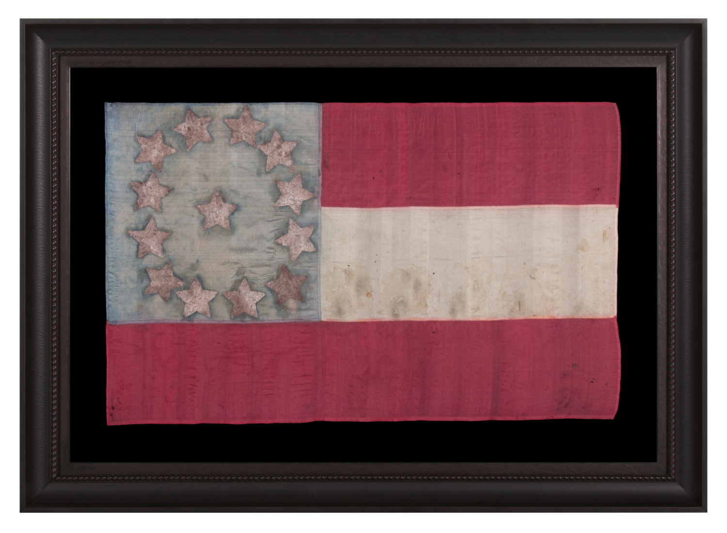 EXTRAORDINARY, HOMEMADE, 1ST CONFEDERATE NATIONAL FLAG, MADE OF LADIES’ DRESS SILK, WITH BEAUTIFUL COLORS AND EXCEPTIONAL PRESSED FOIL STARS, POSSIBLY OF NORTH CAROLINA ORIGIN; LIKELY PRESENTED TO AN OFFICER BY A LOVED ONE AND SEEMINGLY DISPLAYED THEREAFTER AS CONDITIONS PERMITTED; CAPTURED OR SEIZED BY CHAPLAIN-TURNED-GENERAL ELIPHALET WHITTLESEY OF MAINE, A STRONG OPPONENT OF SLAVERY, WHO EVENTUALLY LED AN ALL-BLACK REGIMENT (46TH U.S. COLORED TROOPS)