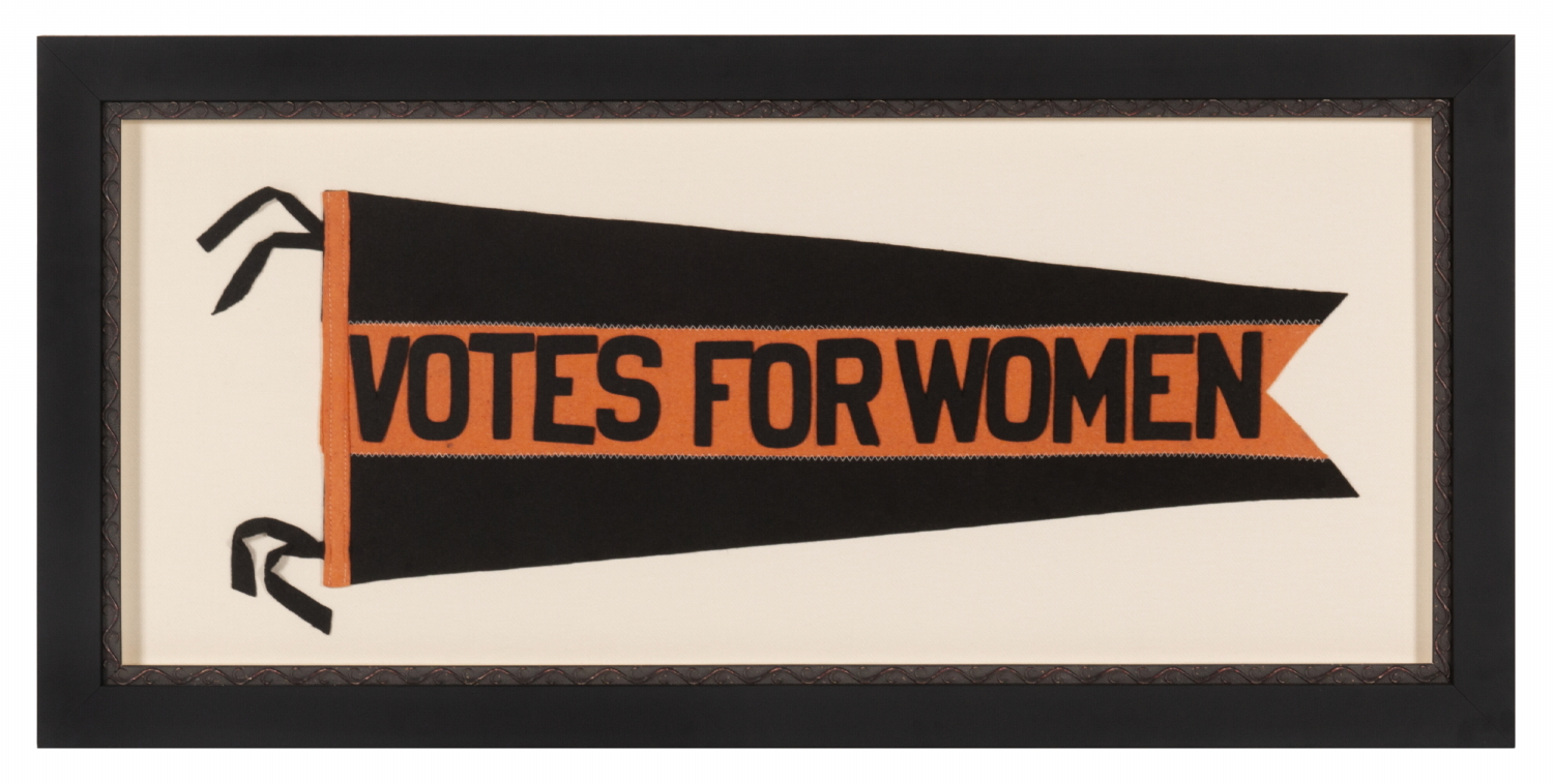 LARGE, SWALLOWTAILED, SUFFRAGETTE PENNANT IN A BLACK & ORANGE COLOR COMBINATION UNIQUE TO THIS EXAMPLE, WITH APPLIED LETTERING THAT READS "VOTES FOR WOMEN” DOWN A WIDE, CENTRAL STRIPE, THIS PRECISE EXAMPLE ILLUSTRATED IN THE BEST REFERENCE ON SUFFRAGE OBJECTS, POSSIBLY WITH TIES TO NEW JERSEY; MADE circa 1912-1919