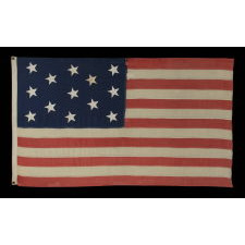 13 CANTED, HAND-SEWN STARS IN A 3-2-3-2-3 PATTERN, ON AN ANTIQUE AMERICAN FLAG MADE IN THE ERA OF THE 1876 CENTENNIAL OF AMERICAN INDEPENDENCE