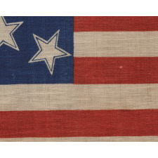 13 HALOED STARS IN A MEDALLION CONFIGURATION, ON AN EXCEPTIONALLY RARE ANTIQUE AMERICAN FLAG MADE FOR THE 1876 CENTENNIAL OF AMERICAN INDEPENDENCE