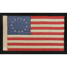 13 HAND-EMBROIDERED STARS AND EXPERTLY HAND-SEWN STRIPES, ON A FLAG MADE BY RACHEL ALBRIGHT, GRANDDAUGHTER OF BETSY ROSS, IN PHILADELPHIA IN 1903, A VERY LARGE EXAMPLE AMONG ITS COUNTERPARTS, WITH A STAR CONFIGURATION THAT IS MORE OVAL THAN CIRCULAR