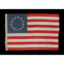 13 HAND-EMBROIDERED STARS AND EXPERTLY HAND-SEWN STRIPES ON AN ANTIQUE AMERICAN FLAG MADE IN PHILADELPHIA BY SARAH M. WILSON, GREAT-GRANDDAUGHTER OF BETSY ROSS, SIGNED & DATED 1910; THE LARGEST KNOWN EXAMPLE OF THIS VARIETY, MADE AND SOLD TO TOURISTS AT INDEPENDENCE HALL