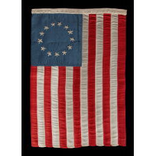 13 HAND-EMBROIDERED STARS AND EXPERTLY HAND-SEWN STRIPES ON AN ANTIQUE AMERICAN FLAG MADE IN PHILADELPHIA BY SARAH M. WILSON, GREAT-GRANDDAUGHTER OF BETSY ROSS, SIGNED & DATED 1910; THE LARGEST KNOWN EXAMPLE OF THIS VARIETY, MADE AND SOLD TO TOURISTS AT INDEPENDENCE HALL