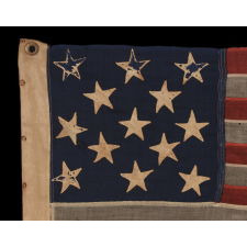 13 HAND-SEWN STARS IN A 3-2-3-2-3 PATTERN ON AN ANTIQUE AMERICAN FLAG WITH ENDEARING WEAR FROM LONG-TERM USE, PROBABLY MADE DURING THE AMERICAN CIVIL WAR (1861-65), AND POSSIBLY ONCE BELONGING TO CIVIL WAR GENERAL AND SECRETARY OF THE NAVY BENJAMIN FRANKLIN TRACY