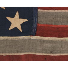 13 HAND-SEWN STARS IN A 3-2-3-2-3 PATTERN ON AN ANTIQUE AMERICAN FLAG WITH ENDEARING WEAR FROM LONG-TERM USE, PROBABLY MADE DURING THE AMERICAN CIVIL WAR (1861-65), AND POSSIBLY ONCE BELONGING TO CIVIL WAR GENERAL AND SECRETARY OF THE NAVY BENJAMIN FRANKLIN TRACY