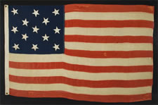 13 HAND-SEWN STARS IN A 3-2-3-2-3 CONFIGURATION, CA 1864-1876, PROBABLY MADE FOR THE CENTENNIAL OF AMERICAN INDEPENDENCE