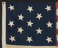 13 HAND-SEWN STARS IN A 3-2-3-2-3 CONFIGURATION, CA 1864-1876, PROBABLY MADE FOR THE CENTENNIAL OF AMERICAN INDEPENDENCE