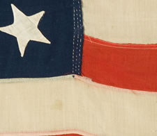 13 HAND-SEWN STARS IN A 3-2-3-2-3 CONFIGURATION, CA 1864-1876, PROBABLY MADE FOR THE CENTENNIAL OF AMERICAN INDEPENDENCE