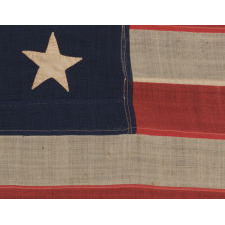 13 HAND-SEWN STARS IN A 3-2-3-2-3 PATTERN ON A U.S. NAVY SMALL BOAT ENSIGN OF THE CENTENNIAL ERA, ca 1870-1882