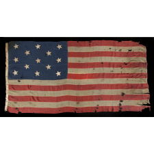 13 HAND-SEWN STARS IN A 3-2-3-2-3 CONFIGURATION OF LINEAL ROWS, ON A LARGE SCALE ANTIQUE AMERICAN FLAG WITH A STENCILED SIGNATURE ALONG THE HOIST THAT READS "GEO L. WRIGHT. BOYLSTON. MA.", PROBABLY MADE FOR THE 100-YEAR ANNIVERSARY OF AMERICAN INDEPENDENCE IN 1876