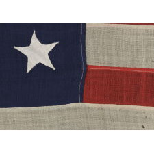 13 HAND-SEWN STARS ON AN ANTIQUE AMERICAN FLAG OF THE 1876 ERA, PROBABLY A U.S. NAVY SMALL BOAT ENSIGN