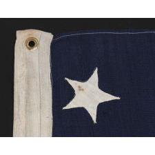 13 HAND-SEWN STARS ON AN ANTIQUE AMERICAN FLAG OF THE 1876 ERA, PROBABLY A U.S. NAVY SMALL BOAT ENSIGN