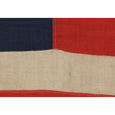 13 HAND-SEWN STARS IN A BEAUTIFUL MEDALLION CONFIGURATION ON A SMALL SCALE ANTIQUE AMERICAN FLAG OF THE 1876 CENTENNIAL ERA