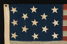 13 HAND-SEWN STARS ON A FLAG WITH ELONGATED PROPORTIONS, IN A RARE, SMALL SIZE FOR THE PERIOD, 1876 CENTENNIAL ERA