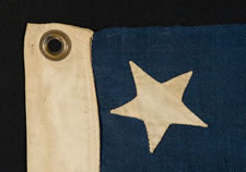 13 HAND-SEWN STARS ON A FLAG WITH ELONGATED PROPORTIONS, IN A RARE, SMALL SIZE FOR THE PERIOD, 1876 CENTENNIAL ERA