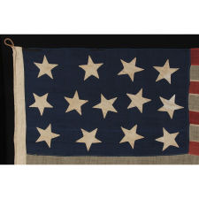 13 HUGE STARS, HAPHAZARDLY CONFIGURED IN A 4-5-4 PATTERN, ON A STRIKINGLY GRAPHIC FLAG OF THE CIVIL WAR ERA, MARKED “BIG BAY” AND PROBABLY EMPLOYED IN U.S. ARMY OR NAVY SERVICE