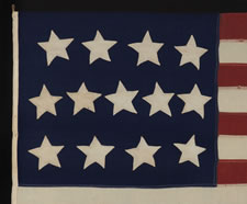 13 LARGE STARS IN THE 4-5-4 PATTERN ON A BEAUTIFULLY GRAPHIC FLAG MADE BETWEEN 1864 AND THE 1876 CENTENNIAL OF AMERICAN INDEPENDENCE,  A U.S. NAVY SMALL BOAT ENSIGN