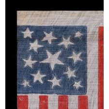 13 STAR AMERICAN PARADE FLAG MADE BETWEEN THE CIVIL WAR (1861-65) AND THE 1876 CENTENNIAL OF AMERICAN INDEPENDENCE, FEATURING THREE SIZES OF WHIMSICALLY SHAPED STARS IN A MEDALLION CONFIGURATION