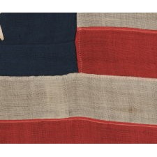 13 STAR ANTIQUE AMERICAN FLAG WITH A BEAUTIFUL MEDALLION CONFIGURATION, A SMALL SCALE EXAMPLE OF THE 1876 CENTENNIAL ERA