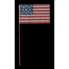 13 STAR ANTIQUE AMERICAN FLAG WITH A MEDALLION CONFIGURATION OF STARS, MADE FOR THE 1876 CENTENNIAL CELEBRATION