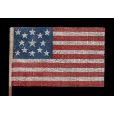 13 STAR ANTIQUE AMERICAN FLAG WITH A MEDALLION CONFIGURATION OF STARS, MADE FOR THE 1876 CENTENNIAL CELEBRATION