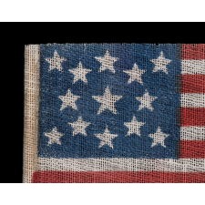 13 STAR ANTIQUE AMERICAN FLAG WITH A MEDALLION CONFIGURATION OF STARS, MADE FOR THE 1876 CENTENNIAL CELEBRATION