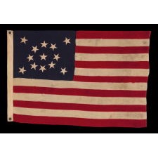 13 STAR ANTIQUE AMERICAN FLAG WITH A BEAUTIFUL MEDALLION CONFIGURATION OF STARS; A SMALL-SCALE EXAMPLE, MADE CIRCA 1895-1926