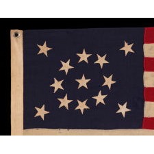 13 STAR ANTIQUE AMERICAN FLAG WITH A BEAUTIFUL MEDALLION CONFIGURATION OF STARS; A SMALL-SCALE EXAMPLE, MADE CIRCA 1895-1926