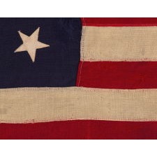 13 STAR ANTIQUE AMERICAN FLAG WITH A BEAUTIFUL MEDALLION CONFIGURATION OF STARS; A SMALL-SCALE EXAMPLE, MADE CIRCA 1895-1926