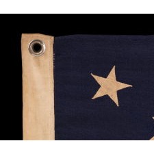 13 STAR ANTIQUE AMERICAN FLAG WITH A BEAUTIFUL MEDALLION CONFIGURATION OF STARS; A SMALL-SCALE EXAMPLE, MADE CIRCA 1895-1926