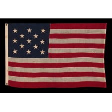 13 STAR ANTIQUE AMERICAN FLAG WITH A 3-2-3-2-3 CONFIGURATION OF STARS; A SMALL-SCALE EXAMPLE, MADE CIRCA 1895-1926