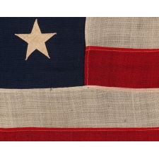 13 STAR ANTIQUE AMERICAN FLAG WITH A 3-2-3-2-3 CONFIGURATION OF STARS; A SMALL-SCALE EXAMPLE, MADE CIRCA 1895-1926