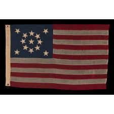 13 STAR ANTIQUE AMERICAN FLAG WITH A BEAUTIFUL MEDALLION CONFIGURATION OF STARS; A SMALL-SCALE EXAMPLE, MADE CIRCA 1895-1926