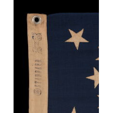 13 STAR ANTIQUE AMERICAN FLAG WITH A BEAUTIFUL MEDALLION CONFIGURATION OF STARS; A SMALL-SCALE EXAMPLE, MADE CIRCA 1895-1926