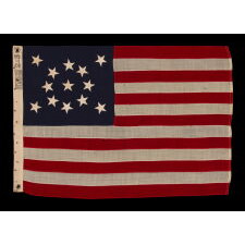 13 STAR ANTIQUE AMERICAN FLAG WITH A MEDALLION CONFIGURATION OF STARS; A SMALL-SCALE EXAMPLE, MADE circa 1895-1926