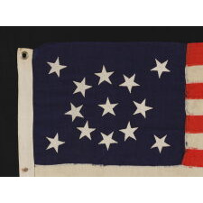 13 STAR ANTIQUE AMERICAN FLAG WITH A MEDALLION CONFIGURATION OF STARS; A SMALL-SCALE EXAMPLE, MADE circa 1895-1926