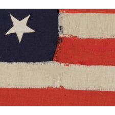 13 STAR ANTIQUE AMERICAN FLAG WITH A MEDALLION CONFIGURATION OF STARS; A SMALL-SCALE EXAMPLE, MADE circa 1895-1926