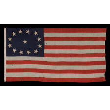 13 STAR ANTIQUE AMERICAN FLAG WITH AN OVAL VERSION OF WHAT IS KNOWN AS THE 3RD MARYLAND PATTERN, MADE IN THE PERIOD BETWEEN THE CIVIL WAR (1861-65) AND THE 1876 CENTENNIAL OF AMERICAN INDEPENDENCE