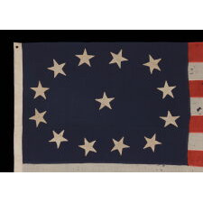 13 STAR ANTIQUE AMERICAN FLAG WITH AN OVAL VERSION OF WHAT IS KNOWN AS THE 3RD MARYLAND PATTERN, MADE IN THE PERIOD BETWEEN THE CIVIL WAR (1861-65) AND THE 1876 CENTENNIAL OF AMERICAN INDEPENDENCE