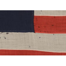 13 STAR ANTIQUE AMERICAN FLAG WITH AN OVAL VERSION OF WHAT IS KNOWN AS THE 3RD MARYLAND PATTERN, MADE IN THE PERIOD BETWEEN THE CIVIL WAR (1861-65) AND THE 1876 CENTENNIAL OF AMERICAN INDEPENDENCE