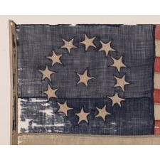 13 STAR FLAG OF THE CIVIL WAR PERIOD (1861-1865), WITH A CIRCULAR VERSION OF WHAT IS KNOWN AS THE 3RD MARYLAND PATTERN AND WITH EXCEPTIONALLY ENDEARING GRAPHIC QUALITIES FROM HAVING BEEN EXTENSIVELY FLOWN, PERHAPS AS A BATTLE FLAG OR TO MARK A SITE IN THE RECRUITMENT OF SOLDIERS