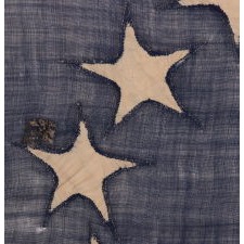 13 STAR FLAG OF THE CIVIL WAR PERIOD (1861-1865), WITH A CIRCULAR VERSION OF WHAT IS KNOWN AS THE 3RD MARYLAND PATTERN AND WITH EXCEPTIONALLY ENDEARING GRAPHIC QUALITIES FROM HAVING BEEN EXTENSIVELY FLOWN, PERHAPS AS A BATTLE FLAG OR TO MARK A SITE IN THE RECRUITMENT OF SOLDIERS