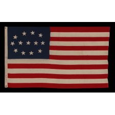 13 STAR FLAG WITH AN ELLIPTICAL MEDALLION OF HAND-SEWN STARS THAT FEATURES A ROW OF THREE IN THE CENTER, A DESIGN IDENTIFIED ON JUST FOUR SURVIVING ANTIQUE FLAGS; CIVIL WAR - CENTENNIAL ERA (1861-1876)