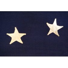 13 STAR FLAG WITH AN ELLIPTICAL MEDALLION OF HAND-SEWN STARS THAT FEATURES A ROW OF THREE IN THE CENTER, A DESIGN IDENTIFIED ON JUST FOUR SURVIVING ANTIQUE FLAGS; CIVIL WAR - CENTENNIAL ERA (1861-1876)