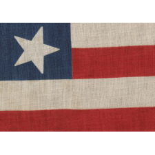 13 STAR PARADE FLAG IN A 3-2-3-2-3 PATTERN, MADE CA 1876-1898, UNUSUALLY LARGE AND WITH AN UNUSUAL STAR PATTERN AMONG ITS COUNTERPARTS OF THE 19TH CENTURY