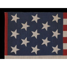 13 STAR PARADE FLAG IN A 3-2-3-2-3 PATTERN, MADE CA 1876-1898, UNUSUALLY LARGE AND WITH AN UNUSUAL STAR PATTERN AMONG ITS COUNTERPARTS OF THE 19TH CENTURY