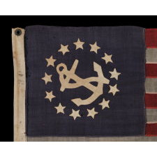 13 STAR PRIVATE YACHT ENSIGN, THE SMALLEST EXAMPLE THAT I HAVE EVER ENCOUNTERED WITH HAND-SEWN STARS AND A CANTED ANCHOR, 1885-1895