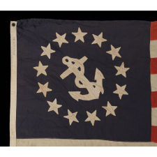 13 STAR PRIVATE YACHT FLAG, WITH HAND-SEWN, SINGLE-APPLIQUÉD STARS AND ANCHOR, MADE BY ANNIN IN NEW YORK CITY, CA 1875-1890, A GREAT, EARLY EXAMPLE AMONG SURVIVING FLAGS IN THIS FORM